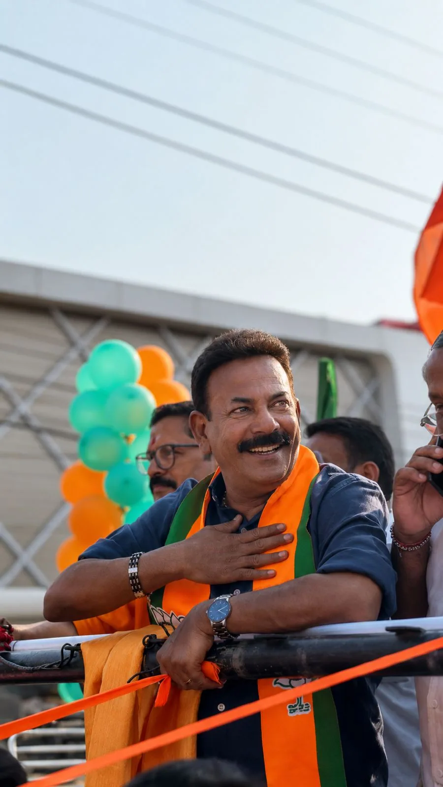 Major Ravi placing his hand on his heart during a rally